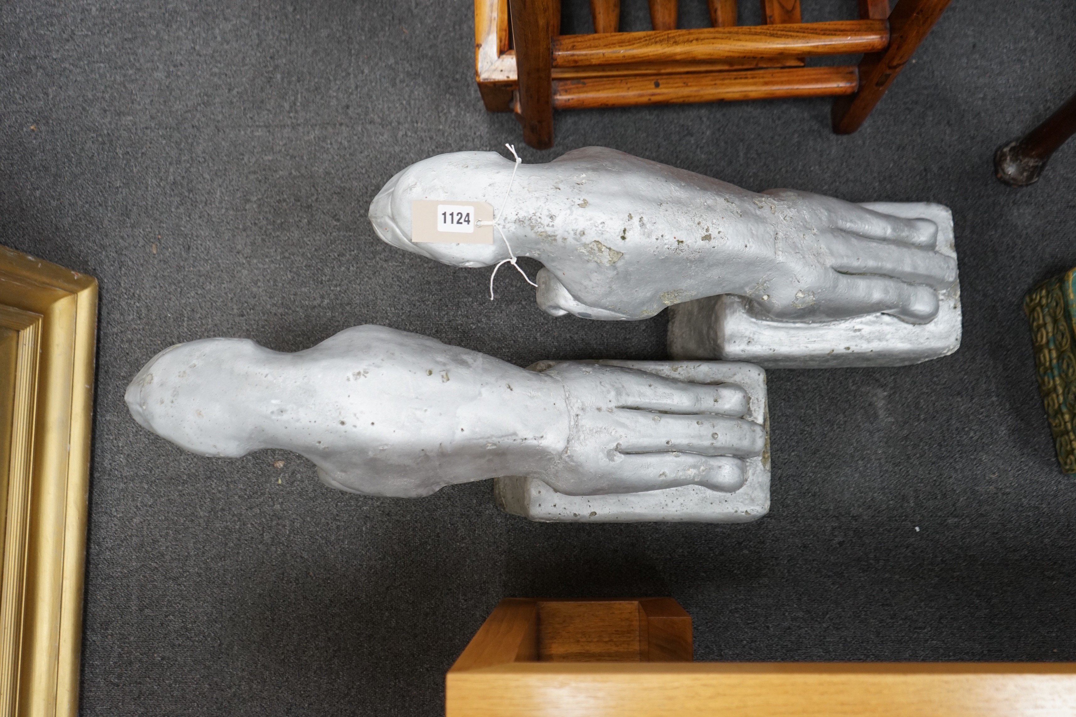 A pair of painted reconstituted stone Jaguars after F.G. Crosby by repute taken from a car dealership, circa 1930, length 60cm, height 36cm